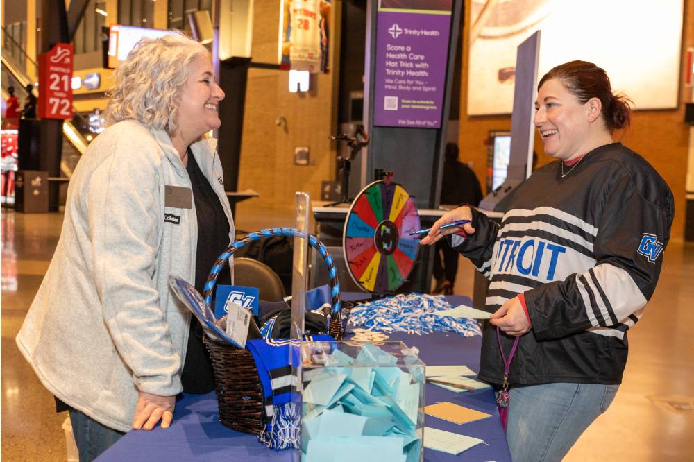 Alum talking to Susan Proctor.